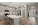 Bright kitchen with a large center island, gray cabinets, stainless steel appliances, and white subway tile at 20108 Stone Pine Cir, Lutz, FL 33558