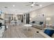 Open-concept living area with modern furniture, kitchen, and dining space at 20108 Stone Pine Cir, Lutz, FL 33558