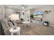 Inviting living room with comfortable seating, ceiling fan and television at 20108 Stone Pine Cir, Lutz, FL 33558