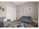 Living room with blue sofa, gray chair, and modern decor at 20108 Stone Pine Cir, Lutz, FL 33558