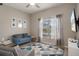 Bright living room featuring a blue sofa, geometric rug, and natural light from the window at 20108 Stone Pine Cir, Lutz, FL 33558