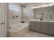 Stylish main bathroom with soaking tub, double vanity, and walk-in shower at 20108 Stone Pine Cir, Lutz, FL 33558