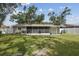 Large fenced backyard with an enclosed porch for outdoor enjoyment at 2044 Balfour Cir, Tampa, FL 33619