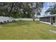 Covered porch leading to large fenced backyard with mature trees at 2044 Balfour Cir, Tampa, FL 33619