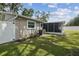 Side yard featuring an enclosed porch for outdoor enjoyment at 2044 Balfour Cir, Tampa, FL 33619