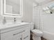 Modern bathroom features a vanity with chrome hardware, and a tub shower combo with an updated shower curtain at 2044 Balfour Cir, Tampa, FL 33619
