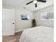 Bright bedroom featuring hardwood floors, a modern TV, and lots of natural light at 2044 Balfour Cir, Tampa, FL 33619