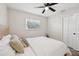 Cozy, neutrally-decorated bedroom with a ceiling fan, a window, and a closet with bi-fold doors at 2044 Balfour Cir, Tampa, FL 33619
