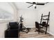 Bedroom featuring wood-look floors, a ceiling fan, and exercise equipment at 2044 Balfour Cir, Tampa, FL 33619