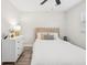 Bright bedroom with a whitewashed headboard, modern decor, and lots of natural light at 2044 Balfour Cir, Tampa, FL 33619
