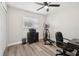 Bedroom featuring wood-look floors, a ceiling fan, and exercise equipment at 2044 Balfour Cir, Tampa, FL 33619