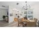 Bright dining area featuring modern lighting and convenient access to the kitchen and outdoor space at 2044 Balfour Cir, Tampa, FL 33619