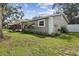 Well-maintained single-story home with a lush green lawn and mature trees at 2044 Balfour Cir, Tampa, FL 33619