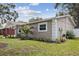 Charming single story home featuring manicured lawn and shaded front patio at 2044 Balfour Cir, Tampa, FL 33619