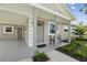 Inviting front entrance with covered porch, seating, and well-maintained landscaping at 2044 Balfour Cir, Tampa, FL 33619