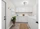 Laundry room with white cabinets, stainless steel hardware, and a window at 2044 Balfour Cir, Tampa, FL 33619
