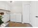 Laundry room with machines, cabinets, white doors and trim at 2044 Balfour Cir, Tampa, FL 33619