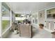 Screened patio with ample seating, plants, and backyard access at 2044 Balfour Cir, Tampa, FL 33619