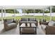 Comfortable sunroom featuring wicker furniture and views of the fenced yard at 2044 Balfour Cir, Tampa, FL 33619