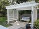 Backyard featuring a pergola, swing and mature landscaping at 2143 Wrens Way, Clearwater, FL 33764
