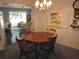 Dining room showcasing a wooden table, chandelier and view of the sunroom at 2143 Wrens Way, Clearwater, FL 33764