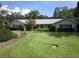 Well-maintained exterior of a single-story home with large front lawn at 2143 Wrens Way, Clearwater, FL 33764