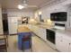 Bright kitchen with white cabinetry and a functional center island at 2143 Wrens Way, Clearwater, FL 33764