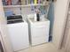 Laundry room featuring modern washer and dryer appliances, cabinetry and storage space at 2143 Wrens Way, Clearwater, FL 33764