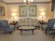 Comfortable living room with elegant furnishings, including a striped sofa and matching armchairs at 2143 Wrens Way, Clearwater, FL 33764