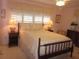 Cozy bedroom with warm lighting, vintage decor, and shuttered windows at 2143 Wrens Way, Clearwater, FL 33764