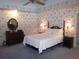 Charming main bedroom with floral wallpaper, ceiling fan and matching dressers and nightstands at 2143 Wrens Way, Clearwater, FL 33764