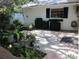 Outdoor patio with tiled floors, potted plants, and built-in gas grill at 2143 Wrens Way, Clearwater, FL 33764