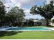 Exterior view of a spacious backyard with large pool and lush landscaping at 2143 Wrens Way, Clearwater, FL 33764