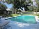 Backyard featuring a large pool, lush landscaping and plenty of patio space for entertaining at 2143 Wrens Way, Clearwater, FL 33764