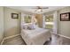 Bright bedroom with large windows, neutral colors, ceiling fan, and wood-look flooring at 2316 Lancaster Dr, Clearwater, FL 33764
