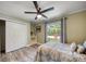 Comfortable bedroom with natural light, closet, ceiling fan, and a large window at 2316 Lancaster Dr, Clearwater, FL 33764
