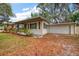 Charming single-story home with a well-manicured lawn and attached two-car garage at 2316 Lancaster Dr, Clearwater, FL 33764