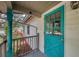 Inviting front porch with a blue door and decorative post welcomes you to this charming home at 2316 Lancaster Dr, Clearwater, FL 33764