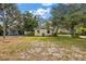 Charming home with a spacious front yard, mature trees, and landscaping at 2316 Lancaster Dr, Clearwater, FL 33764