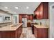 Well-lit kitchen featuring wooden cabinetry, stainless steel appliances, and light countertops at 2316 Lancaster Dr, Clearwater, FL 33764