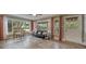 Sun-drenched living room with expansive windows, comfortable seating, and wood-look flooring at 2316 Lancaster Dr, Clearwater, FL 33764