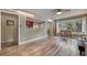 Bright living room features wood floors, a ceiling fan, and a pass-through view to the kitchen at 2316 Lancaster Dr, Clearwater, FL 33764