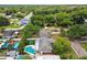 An aerial view of a beautiful home showcasing a pristine pool, putting green, lush landscaping, and backyard oasis at 2560 51St N St, St Petersburg, FL 33710