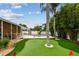 Landscaped backyard with putting green, bamboo, and palm trees create a tropical oasis at 2560 51St N St, St Petersburg, FL 33710