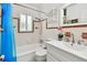 Bright bathroom featuring a shower-over-tub with white tiles, a decorative border, and updated fixtures at 2560 51St N St, St Petersburg, FL 33710