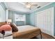 Relaxing bedroom with natural light, hardwood floors, ceiling fan, and closet with sliding doors at 2560 51St N St, St Petersburg, FL 33710
