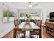 Dining room with a wooden table, six chairs, a ceiling fan, and natural lighting at 2560 51St N St, St Petersburg, FL 33710