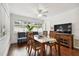 Dining room with hardwood floors, ceiling fan, and view of backyard at 2560 51St N St, St Petersburg, FL 33710