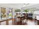Dining room with a wooden table, six chairs, a ceiling fan, and large windows at 2560 51St N St, St Petersburg, FL 33710