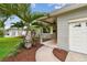 Inviting entrance with a curved walkway, mature palm, and manicured landscaping and brick facade at 2560 51St N St, St Petersburg, FL 33710